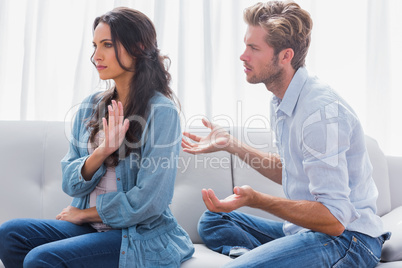 Woman gesturing while quarreling with her partner