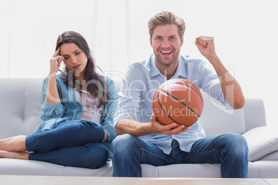 Woman annoyed by her partner watching basketball game