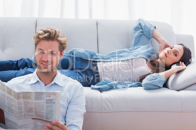 Woman relaxing on a couch listening to music