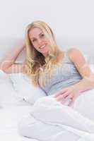 Blonde woman lying on bed