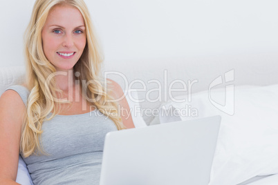 Pretty blonde woman using her laptop