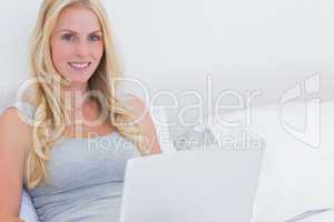 Pretty blonde woman using her laptop