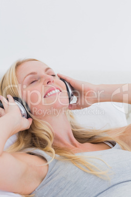 Pretty woman listening to music with headphones