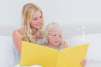 Mother reading a story to her daughter