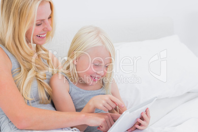 Mother and daughter touching a tablet