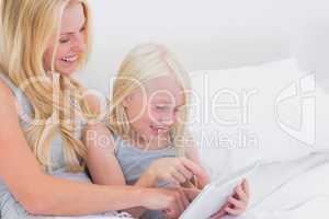 Mother and daughter touching a tablet