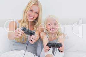 Mother and daughter playing video games