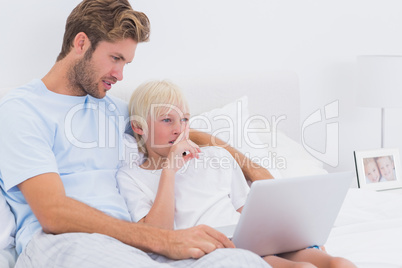 Handsome father and his son using a laptop