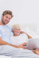 Portrait of a handsome father and his son using a laptop