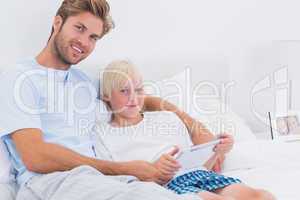 Father and his son using a tablet