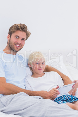 Handsome father and his son using a tablet