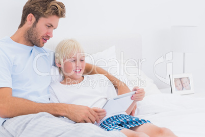 Father and his son using a tablet