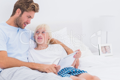 Father and son using a tablet together