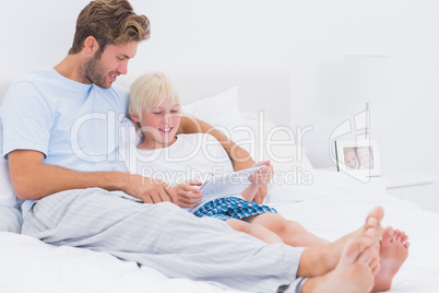 Handsome father and son using a tablet together