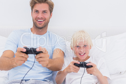 Father and son having fun playing video games