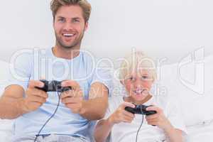 Father and son having fun playing video games