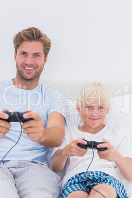 Happy father and son playing video games