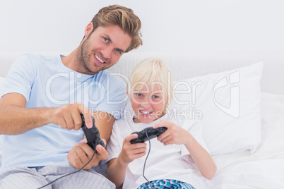 Cheerful father and son playing video games