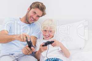 Cheerful father and son playing video games