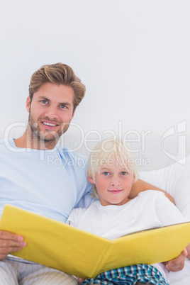 Portrait of a father reading a story to his son