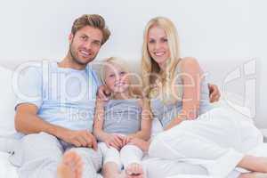 Portrait of a beautiful family in the bed