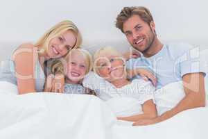 Portrait of a family in bed