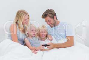 Beautiful family using a smartphone