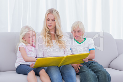 Mother reading a story to children