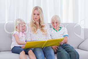 Mother reading a story to children