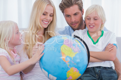 Smiling family with globe