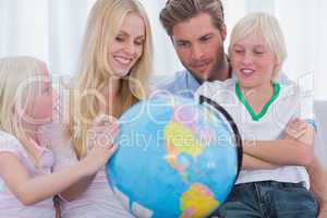 Smiling family with globe