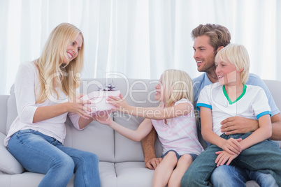 Little girl offering a present to her mother