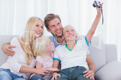 Little boy taking pictures of his family