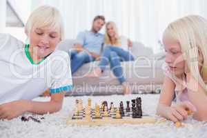 Children playing chess in the living room