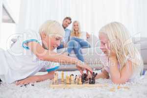 Brother and sister playing chess