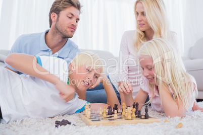 Parents and children playing chess