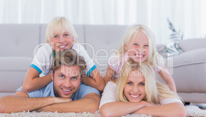 Parents and children lying on the carpet