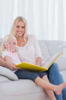 Mother and her daughter reading a book