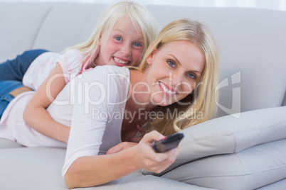 Mother and her daughter watching TV Mother and her daughter watching TV