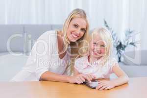 Woman using tablet pc with her daughter