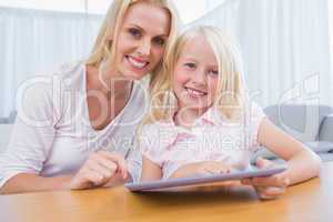 Mother and daughter using tablet pc together