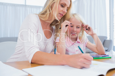 Cute little girl with her mother drawing