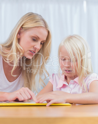 Mother and daughter reading together