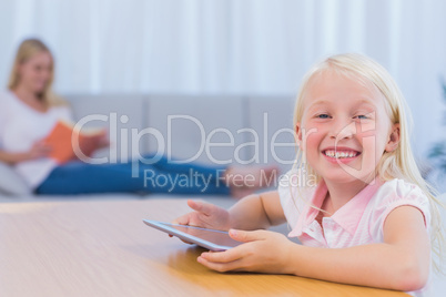 Little girl using tablet pc in the living room