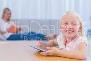 Little girl using tablet pc in the living room