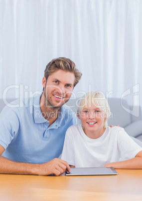 Father using tablet with his son