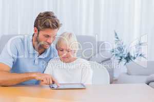 Father and son using tablet pc together