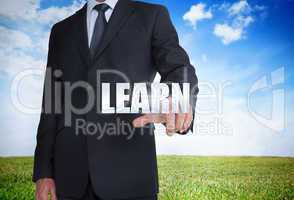 Businessman selecting learn word