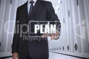 Businessman in a data center selecting label with plan