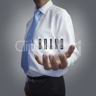 Businessman holding the word brand